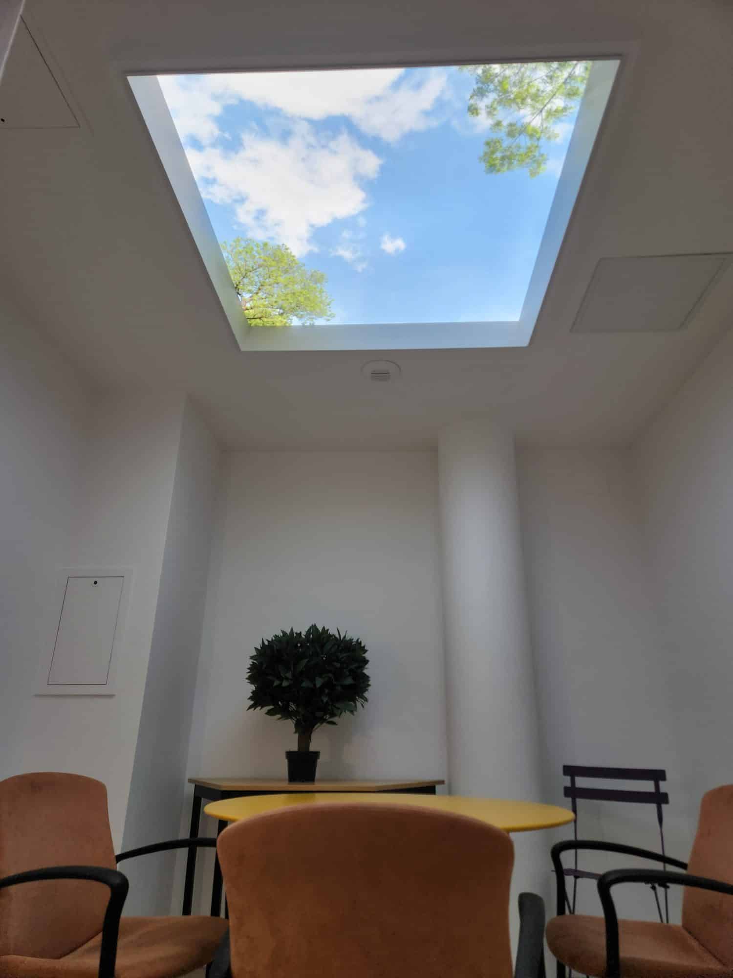 Salle de pause d'un cabinet comptable sous un plafond lumineux Cumulux XL 120x120 cm